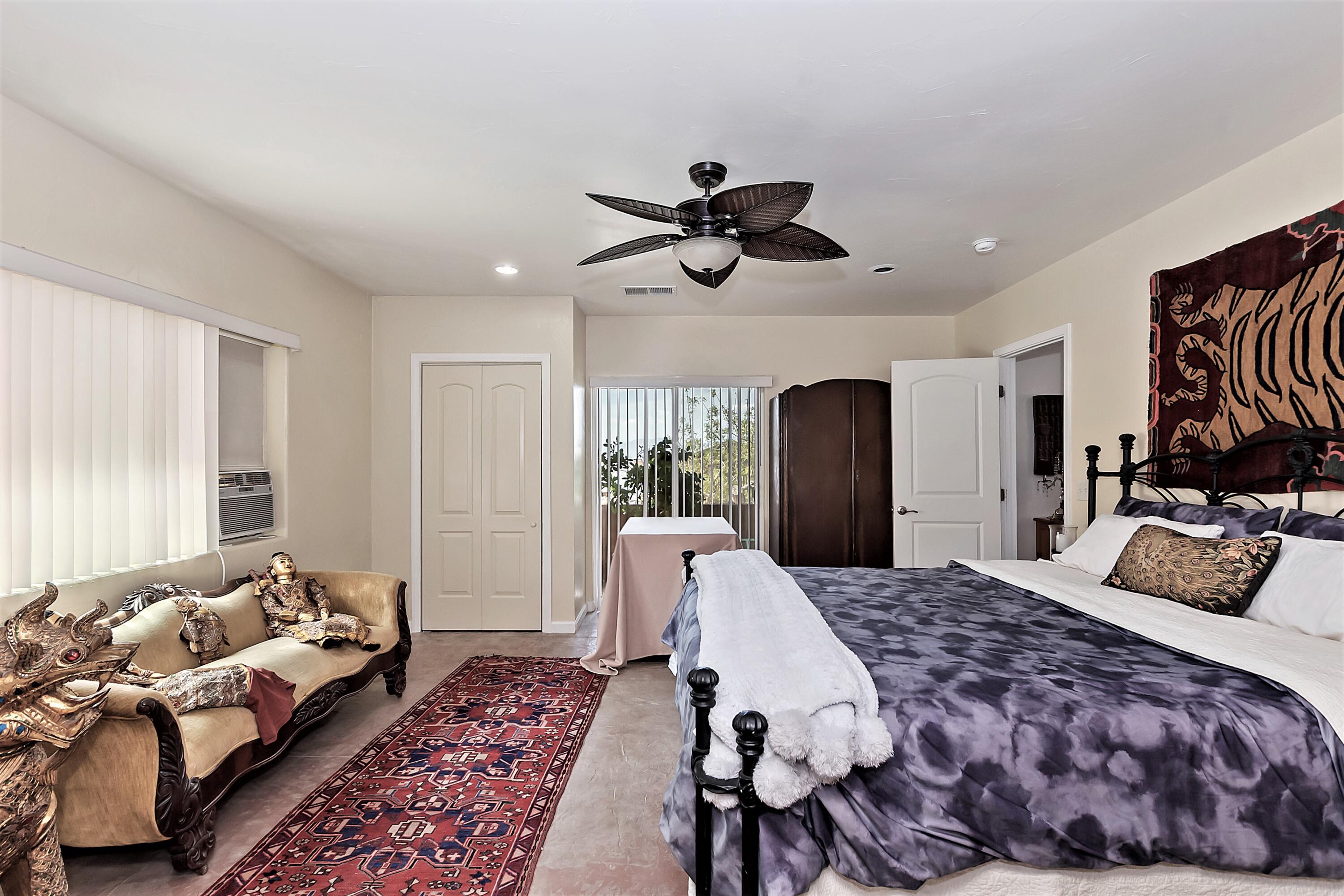 73315 Helms Road Desert Hot Springs, CA 92241 - Photo 26 of 41 a bedroom with a large bed and a chandelier