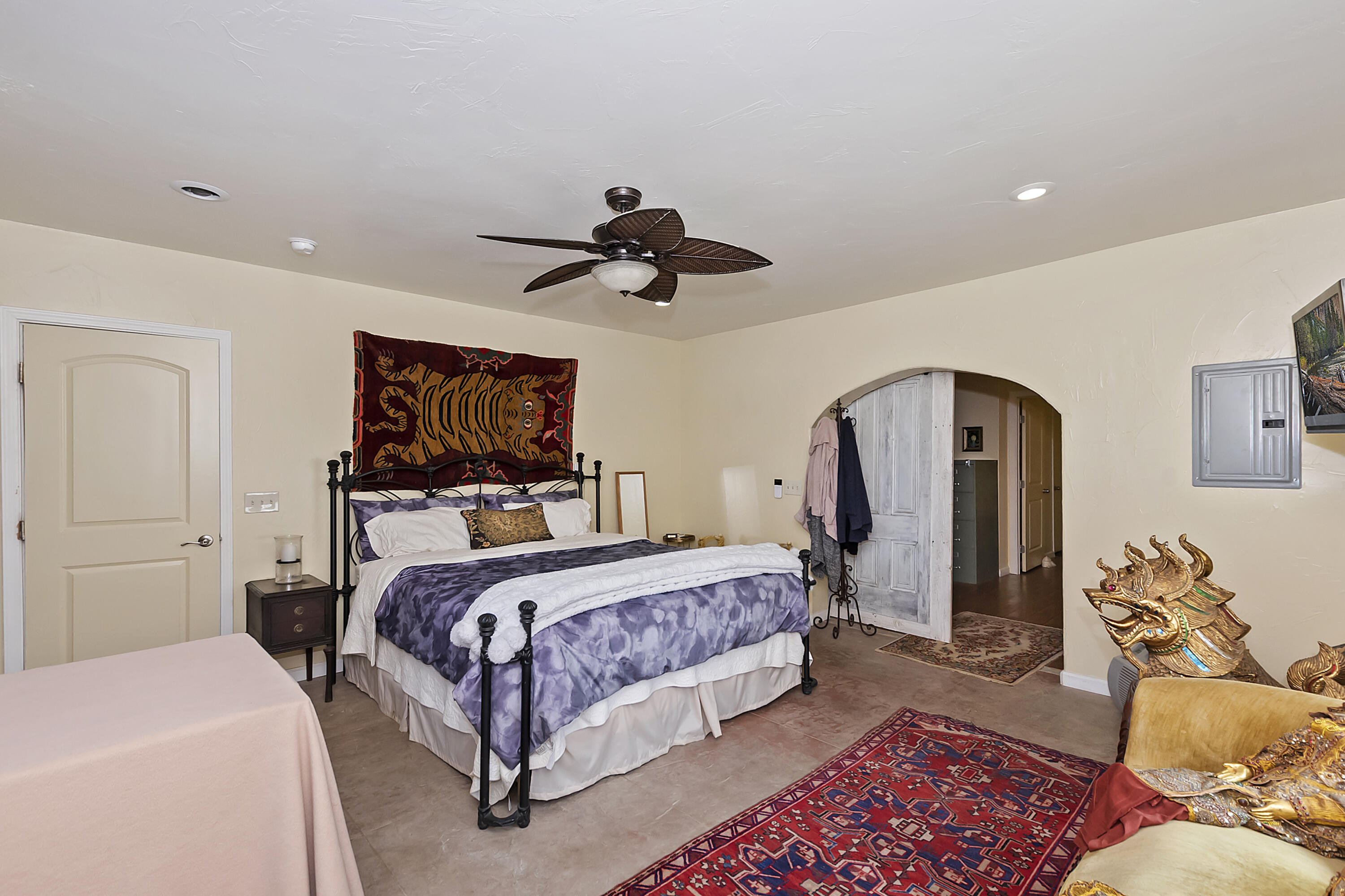 73315 Helms Road Desert Hot Springs, CA 92241 - Photo 27 of 41 a bedroom with a bed and a chandelier