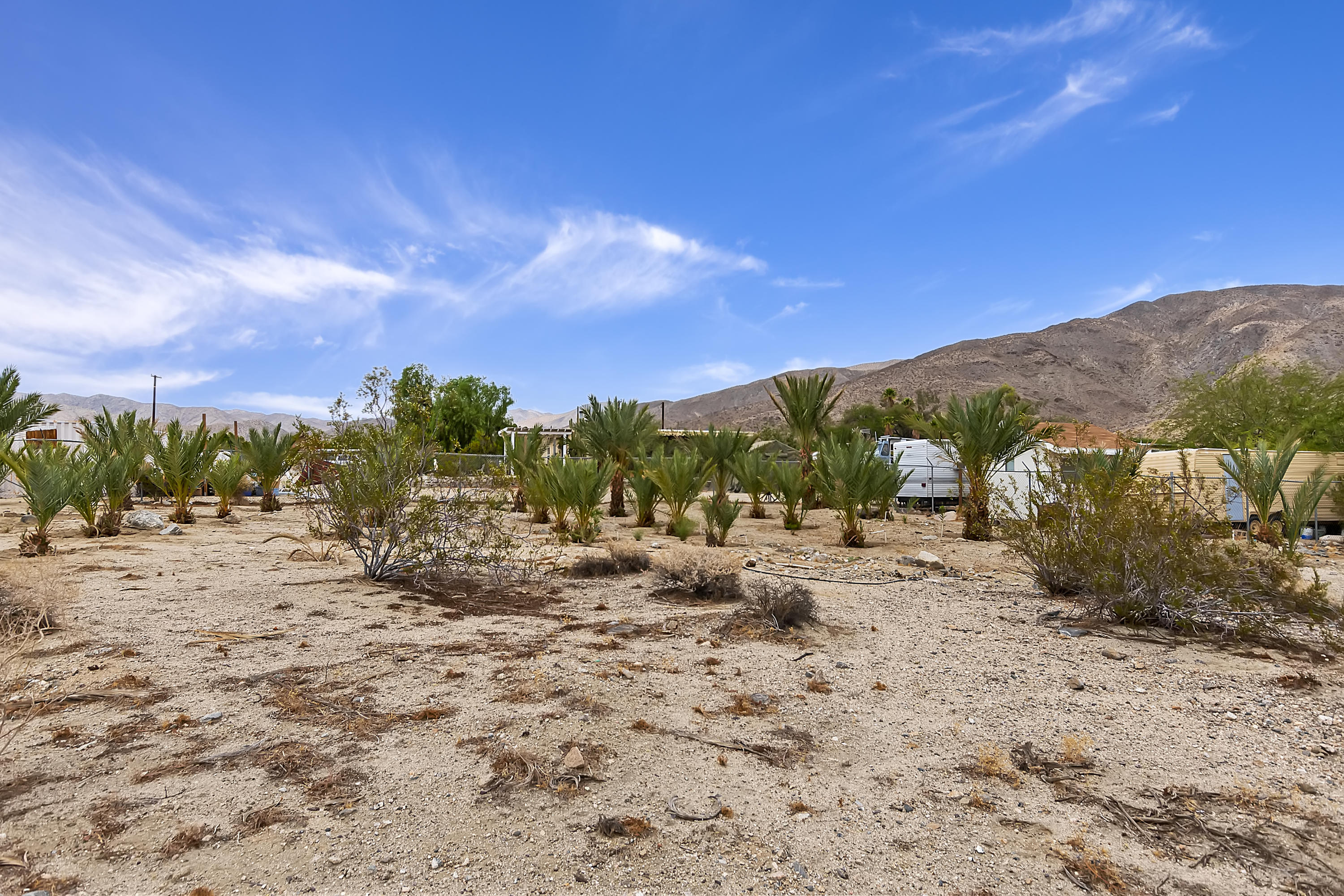 73315 Helms Road Desert Hot Springs, CA 92241 - Photo 41 of 41 a view of a dry yard with wooden fence