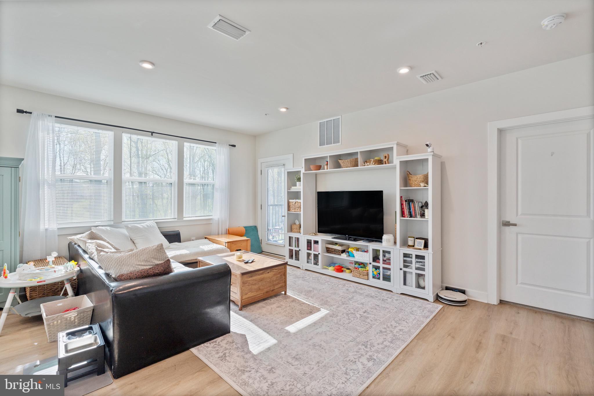 10411 Resort Road, Unit B Ellicott City, MD 21042 - Photo 21 of 36 a living room with furniture and a flat screen tv