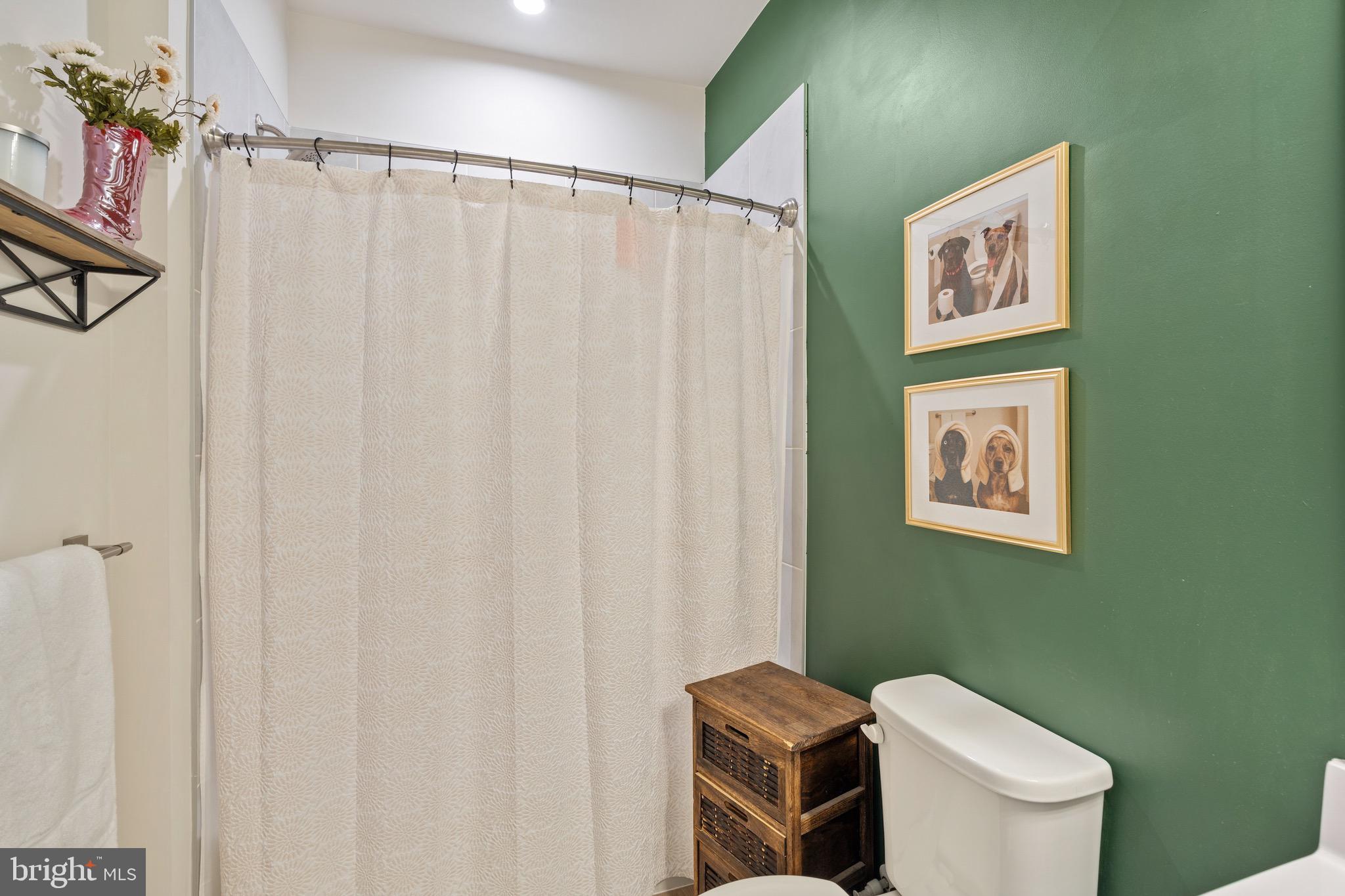 10411 Resort Road, Unit B Ellicott City, MD 21042 - Photo 24 of 36 a white toilet sitting next to a small bathroom