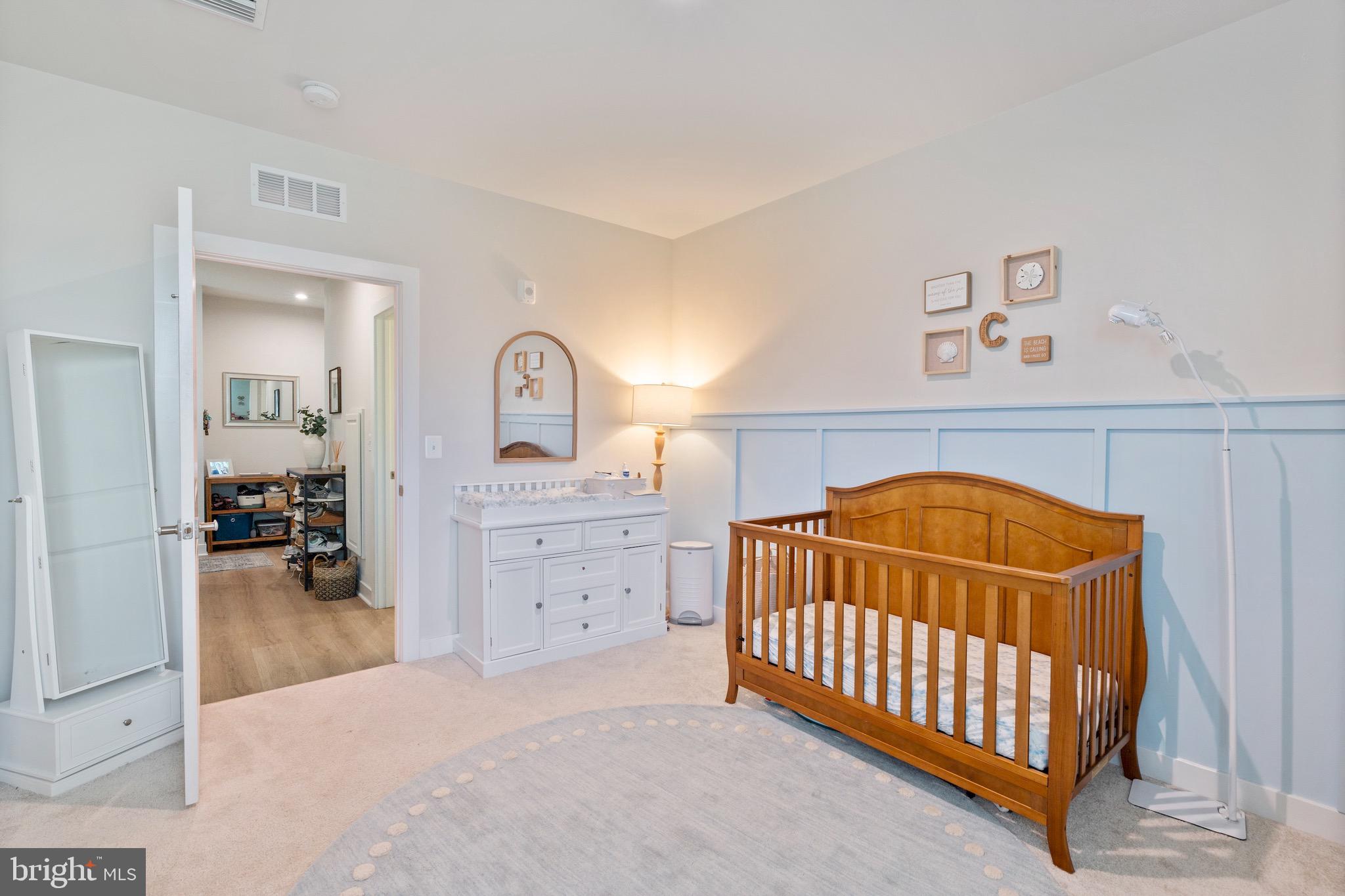 10411 Resort Road, Unit B Ellicott City, MD 21042 - Photo 27 of 36 a bedroom with a baby bed and a dresser