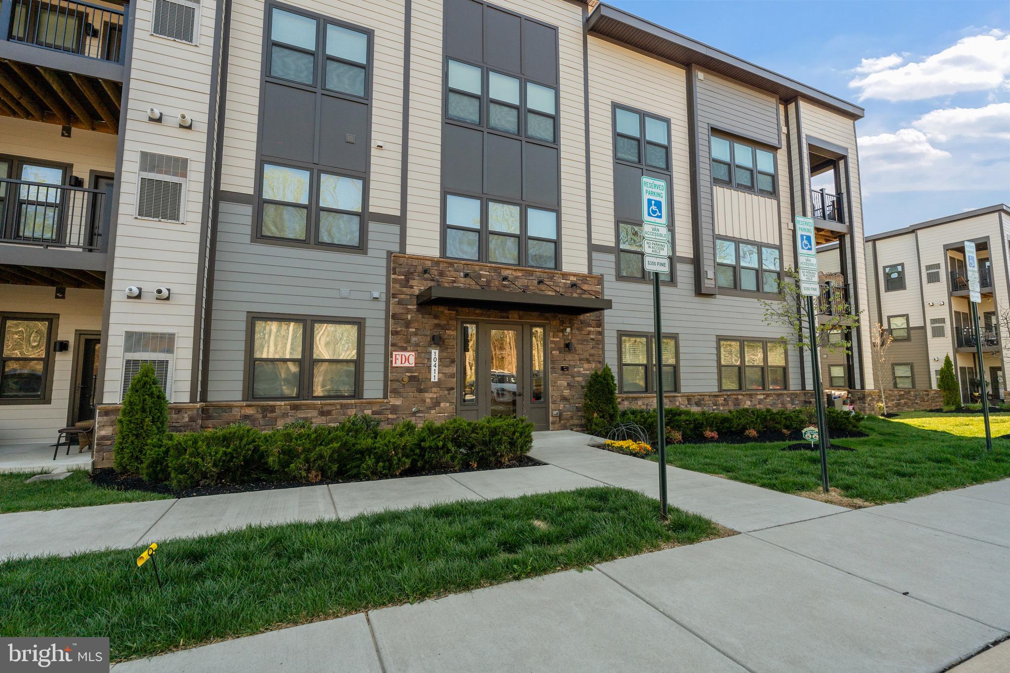10411 Resort Road, Unit B Ellicott City, MD 21042 - Photo 32 of 36 a front view of a residential apartment building with a yard