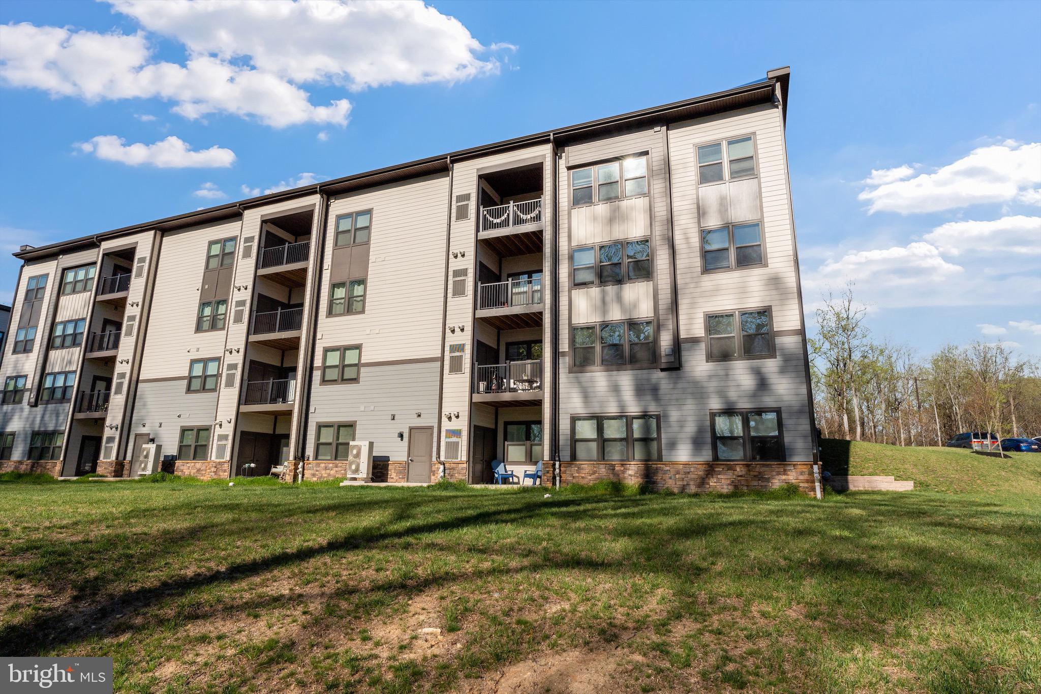 10411 Resort Road, Unit B Ellicott City, MD 21042 - Photo 34 of 36 a view of a building with a yard