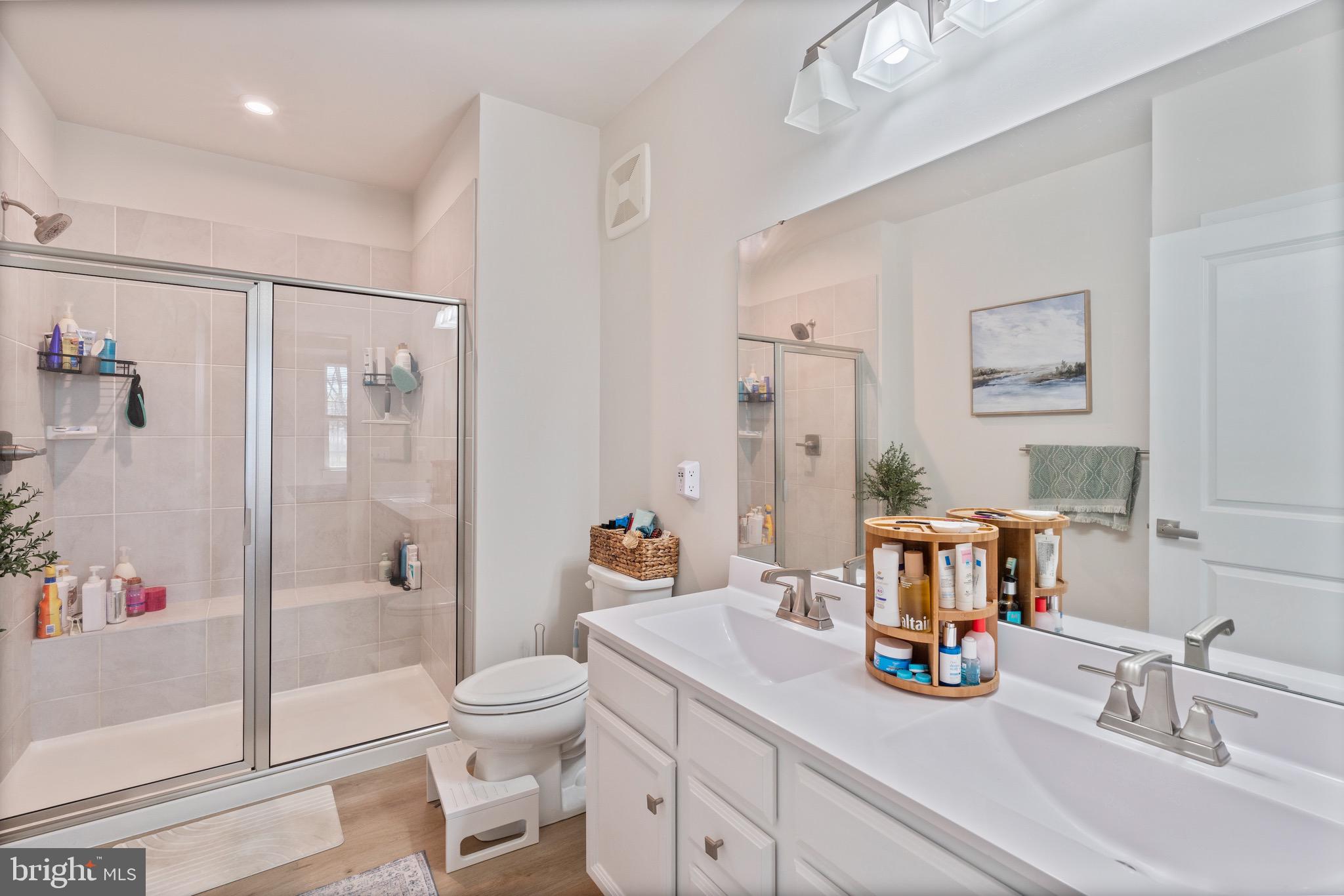 10411 Resort Road, Unit B Ellicott City, MD 21042 - Photo 5 of 36 a bathroom with a sink a toilet and shower