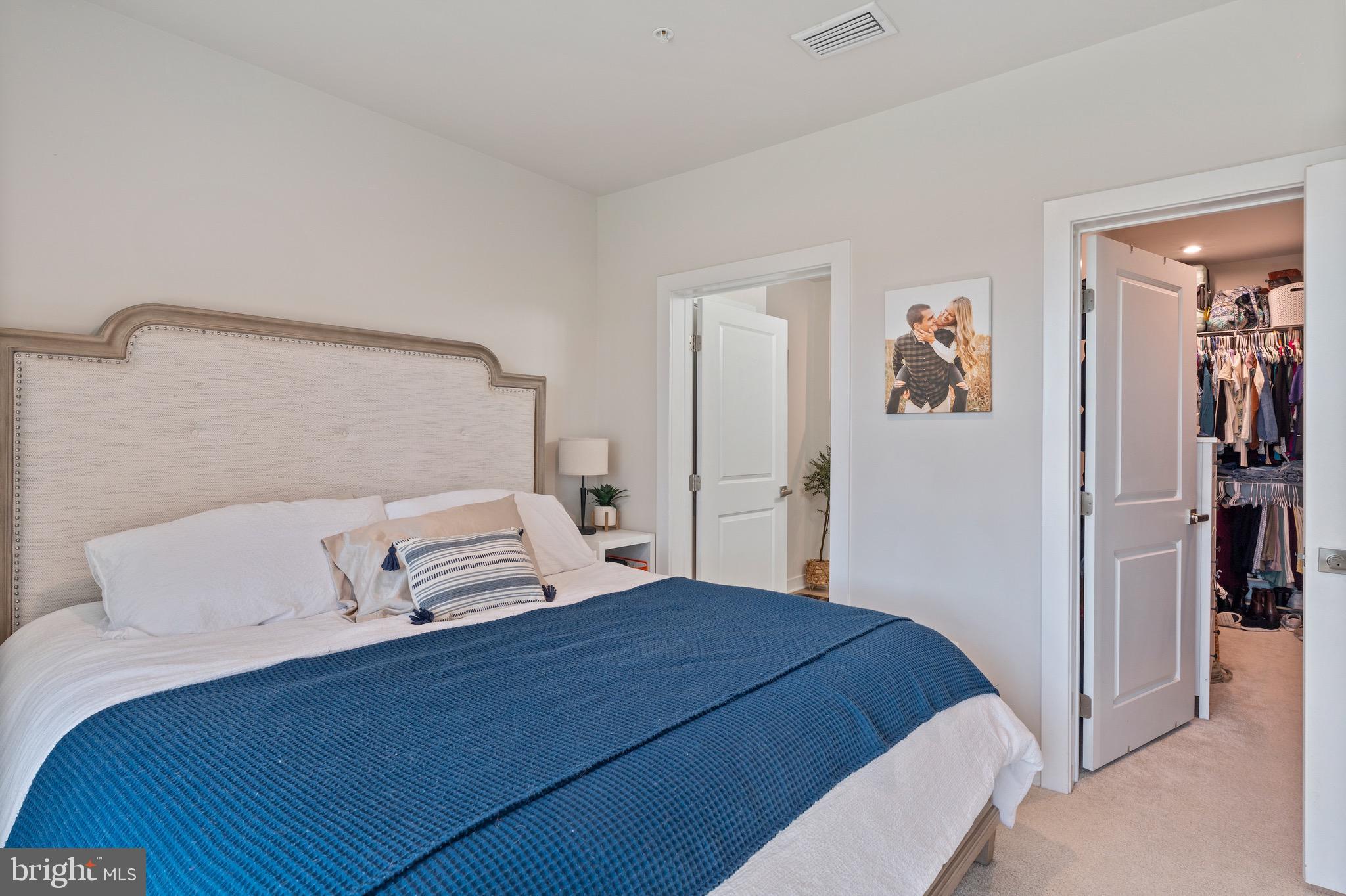 10411 Resort Road, Unit B Ellicott City, MD 21042 - Photo 9 of 36 a bedroom with a bed and painting on the wall