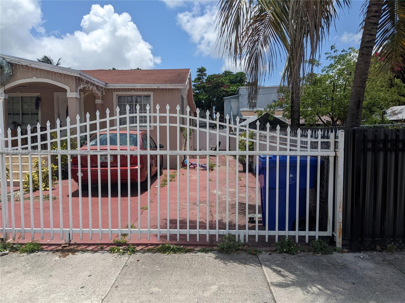 Allapattah Miami, FL 33142 - Photo 4 of 4 a view of a house with a small yard and wooden fence