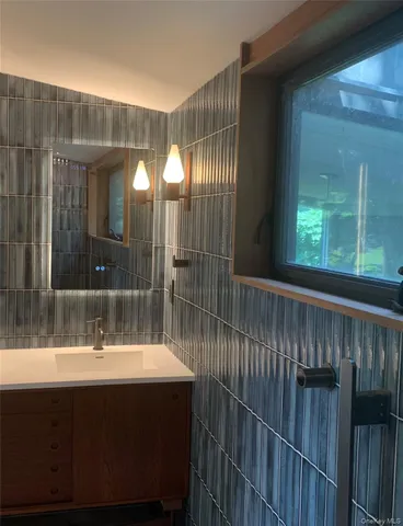 a bedroom with furniture and a large window