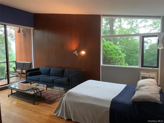 a bedroom with a bed and a large window