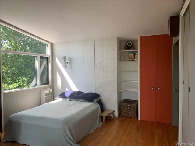 a view of balcony with wooden floor & fence