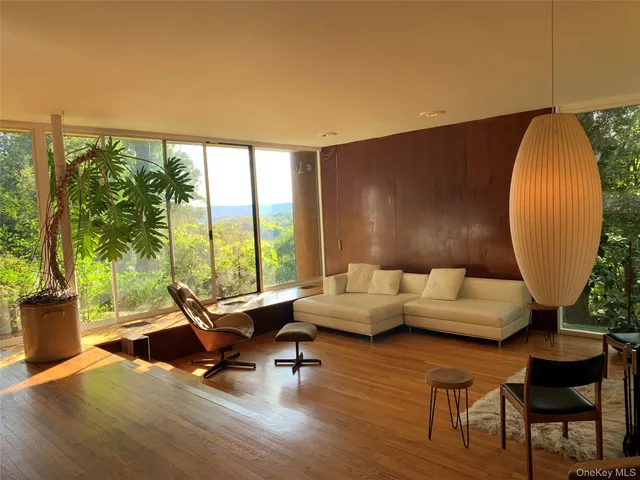 a room with wooden floor and windows