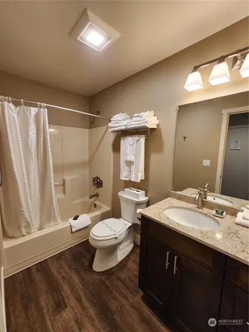 a bathroom with a sink vanity mirror and toilet