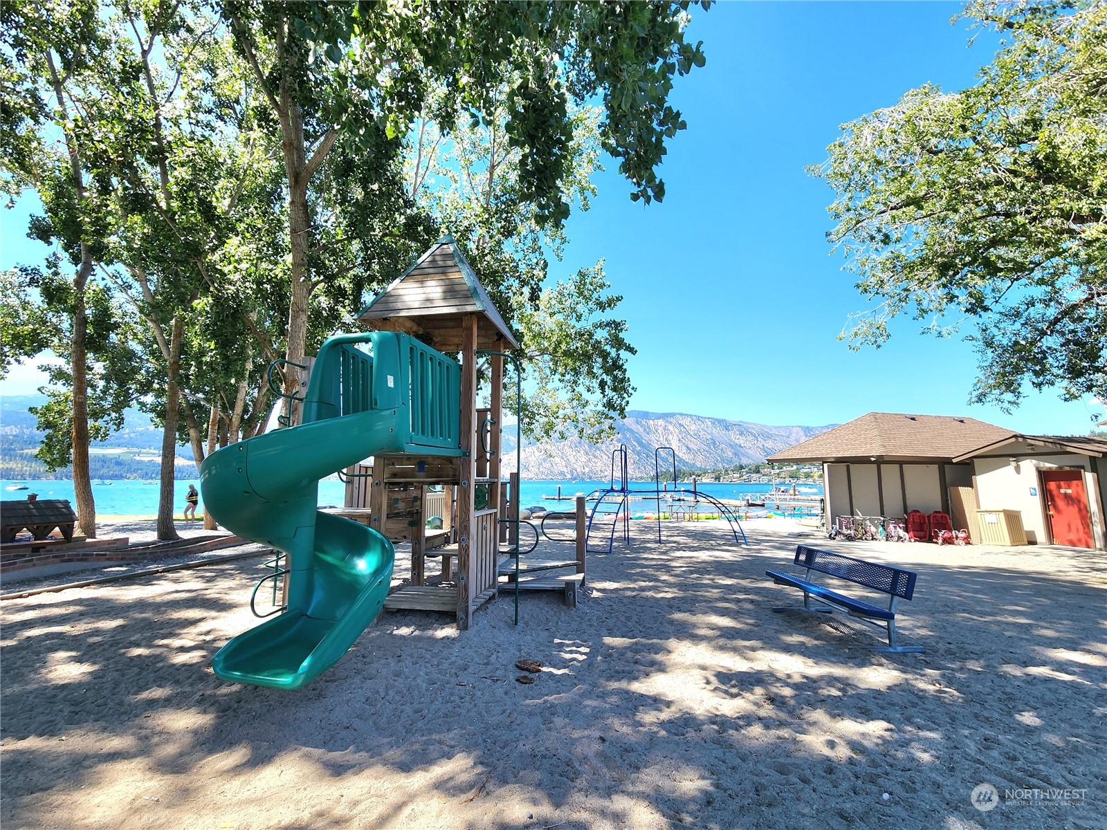 1 Lakeside 707-j Manson, WA 98831 - Photo 32 of 40 a patio with a table and chairs under an umbrella