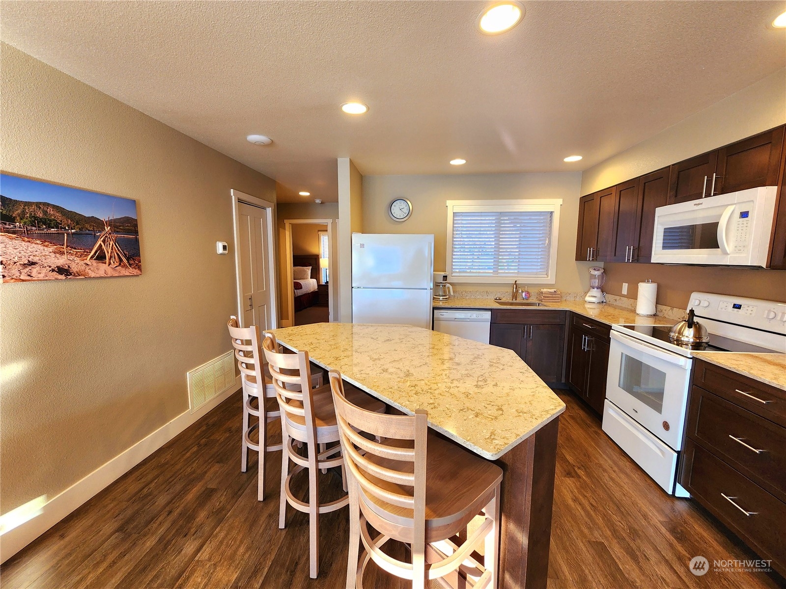 1 Lakeside 707-j Manson, WA 98831 - Photo 10 of 40 a kitchen with granite countertop kitchen island wooden floor center island and stainless steel appliances