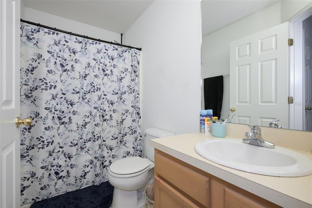 11 Riddle Drive Palm Coast, FL 32164 - Photo 17 of 33 a bathroom with a sink toilet and a mirror