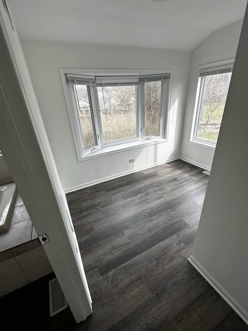 730 Hageman Place Naperville, IL 60563 - Photo 16 of 25 a view of an empty room with wooden floor and window