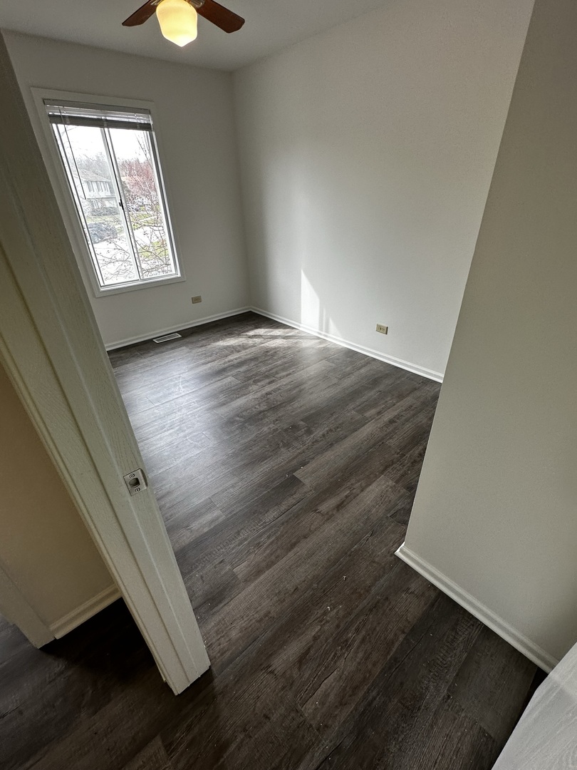 730 Hageman Place Naperville, IL 60563 - Photo 18 of 25 an empty room with wooden floor and windows
