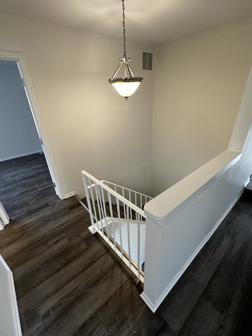 730 Hageman Place Naperville, IL 60563 - Photo 19 of 25 a view of staircase with wooden floor and white walls