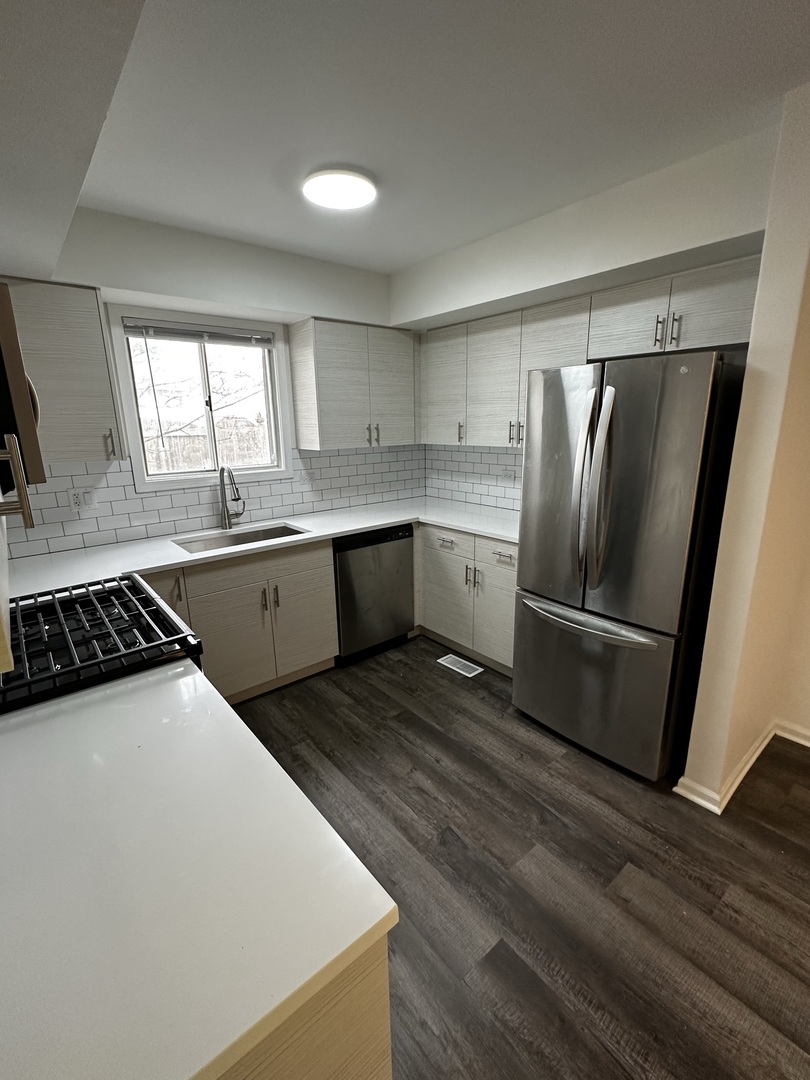730 Hageman Place Naperville, IL 60563 - Photo 2 of 25 a kitchen with stainless steel appliances granite countertop a sink stove and refrigerator