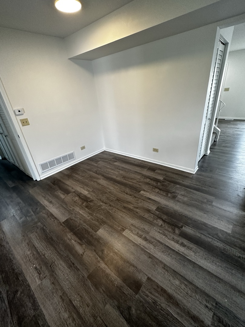 730 Hageman Place Naperville, IL 60563 - Photo 23 of 25 a view of an empty room with wooden floor and a window