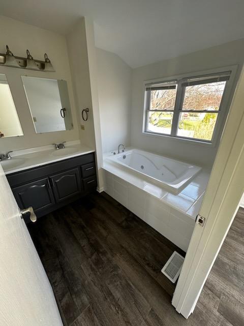 730 Hageman Place Naperville, IL 60563 - Photo 10 of 25 a bathroom with a double vanity sink a bathtub and a window