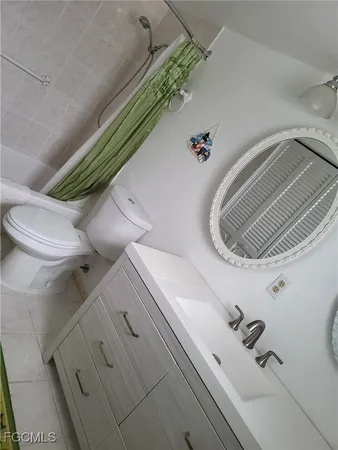 a bathroom with a toilet and shower