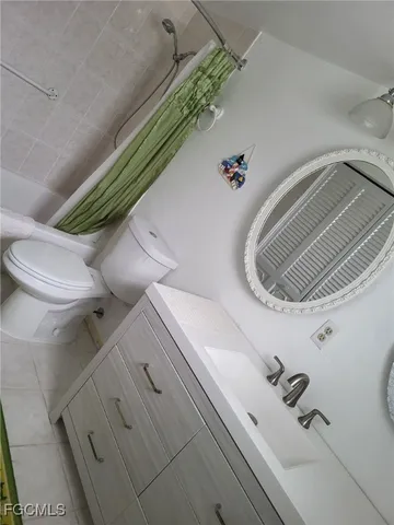 a bathroom with a toilet and shower