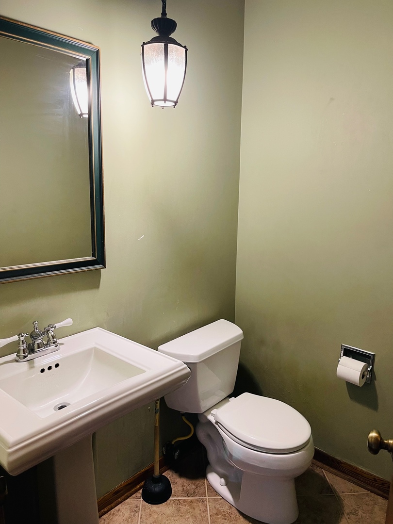 2013 Hickory Street Waukegan, IL 60087 - Photo 18 of 25 a bathroom with a sink a toilet and mirror