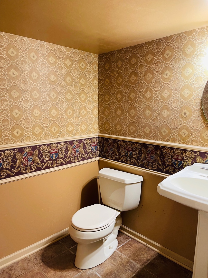 2013 Hickory Street Waukegan, IL 60087 - Photo 20 of 25 a bathroom with a toilet a sink and mirror