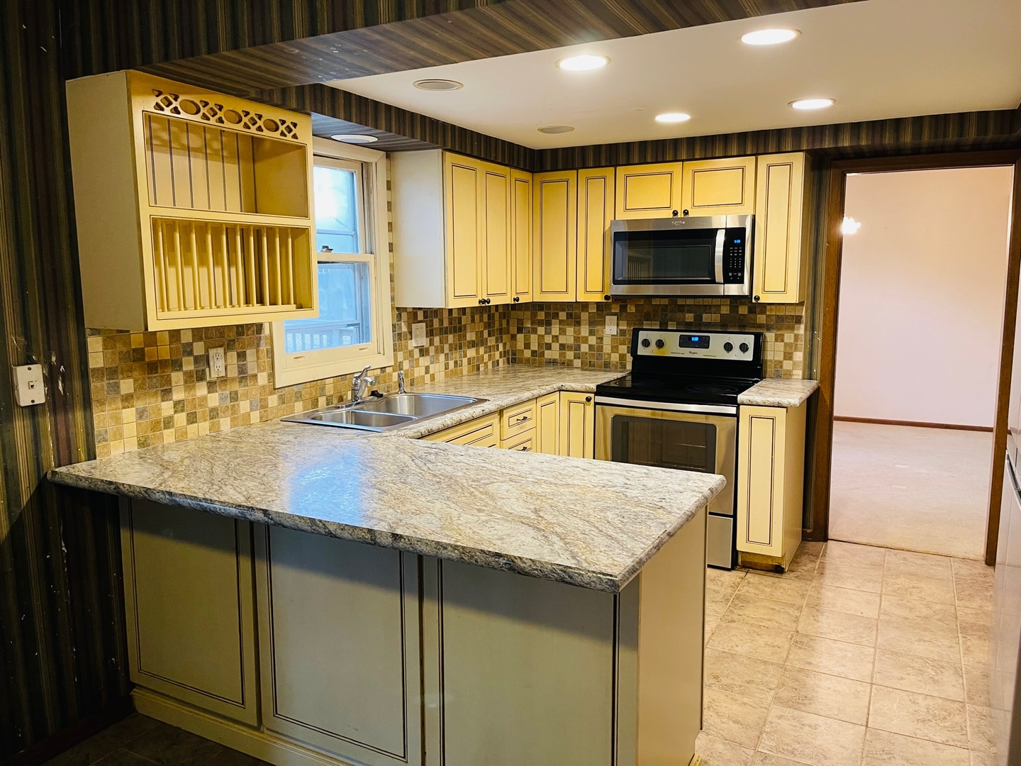 2013 Hickory Street Waukegan, IL 60087 - Photo 2 of 25 a kitchen with stainless steel appliances a stove a sink a microwave a refrigerator and cabinets