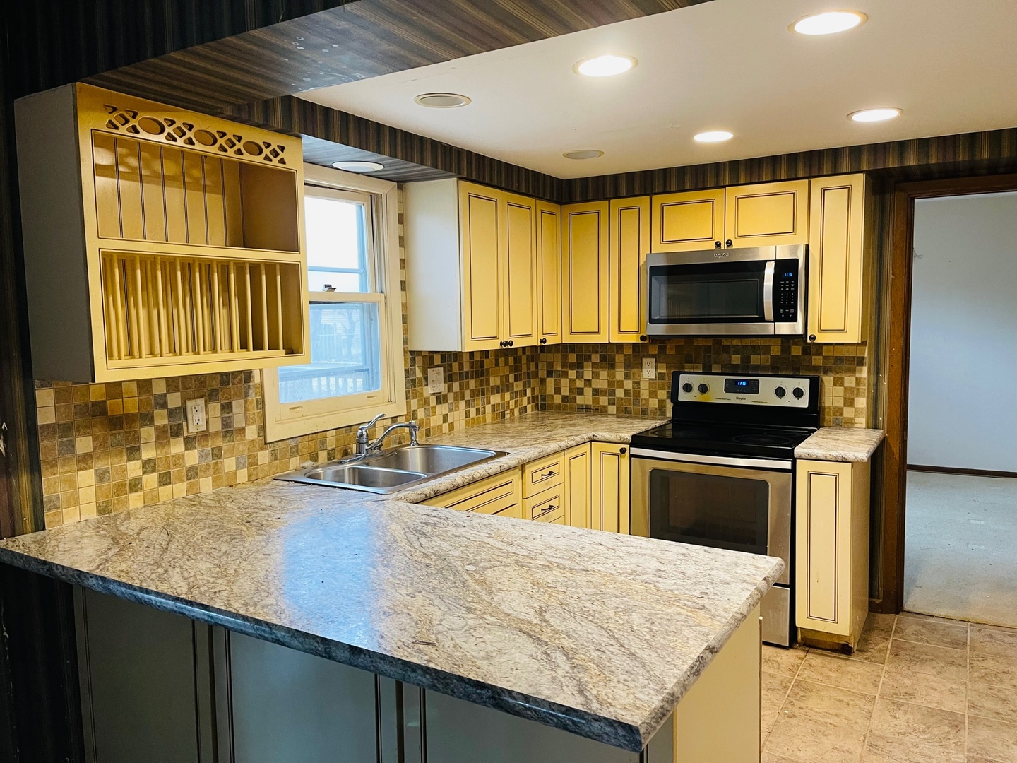 2013 Hickory Street Waukegan, IL 60087 - Photo 7 of 25 a kitchen with granite countertop a sink a counter top space appliances and cabinets