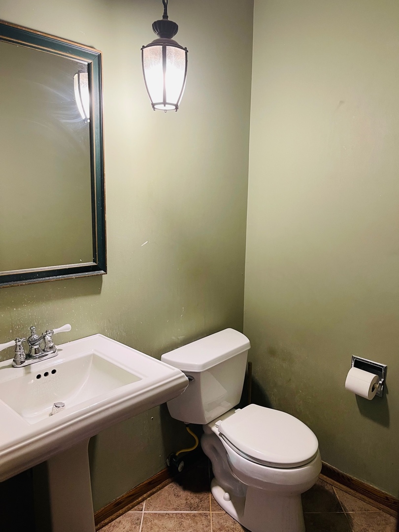 2013 Hickory Street Waukegan, IL 60087 - Photo 8 of 25 a bathroom with a sink a toilet and mirror