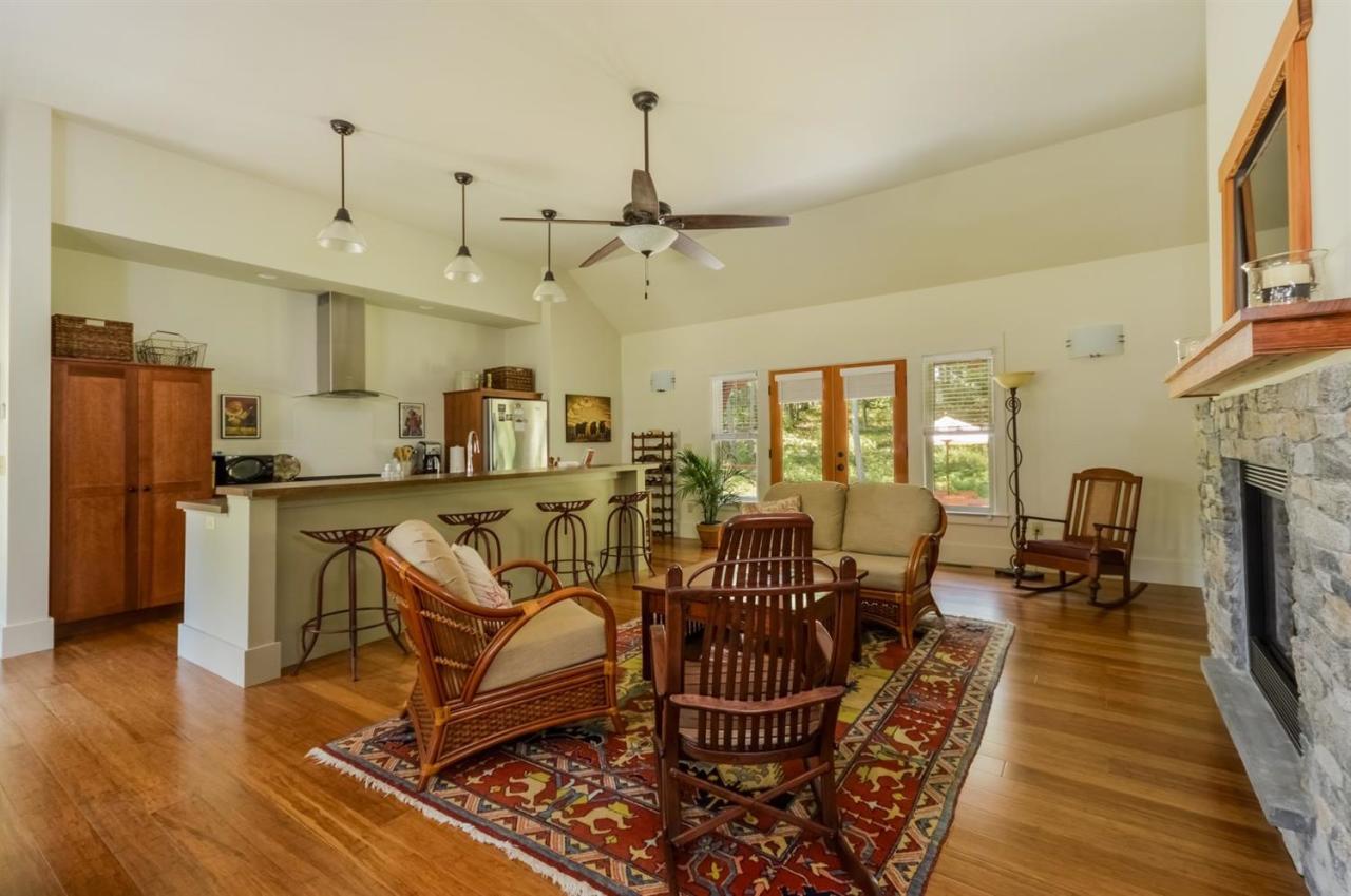 1336 Old Post Road Marstons Mills, MA 02648 - Photo 1 of 16 a living room with furniture a fireplace and wooden floor