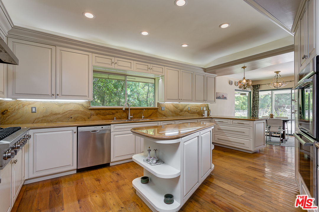 1040 Maybrook Drive Beverly Hills, CA 90210 - Photo 11 of 31 a kitchen with a sink stove and cabinets