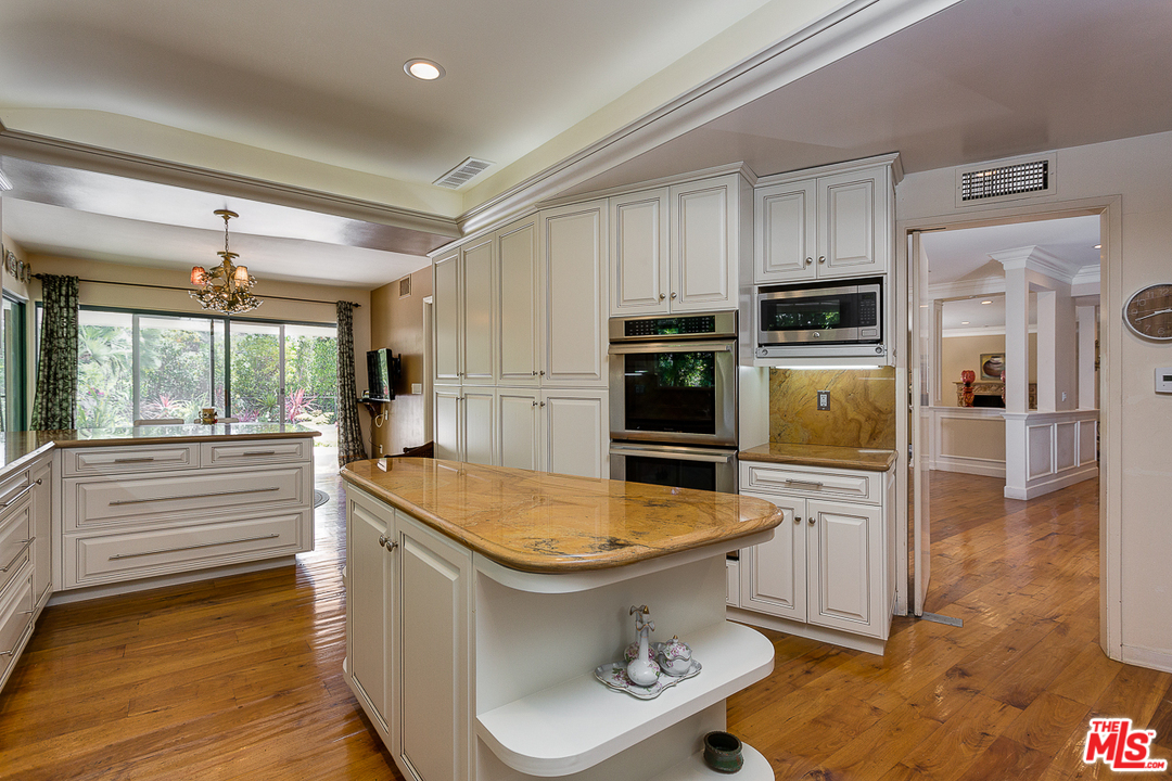 1040 Maybrook Drive Beverly Hills, CA 90210 - Photo 12 of 31 a kitchen with stainless steel appliances granite countertop a sink and a refrigerator