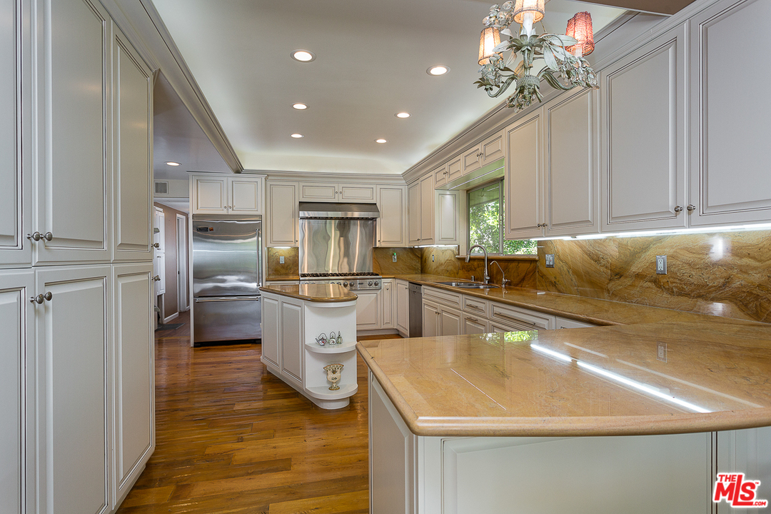 1040 Maybrook Drive Beverly Hills, CA 90210 - Photo 13 of 31 a kitchen with refrigerator and cabinets