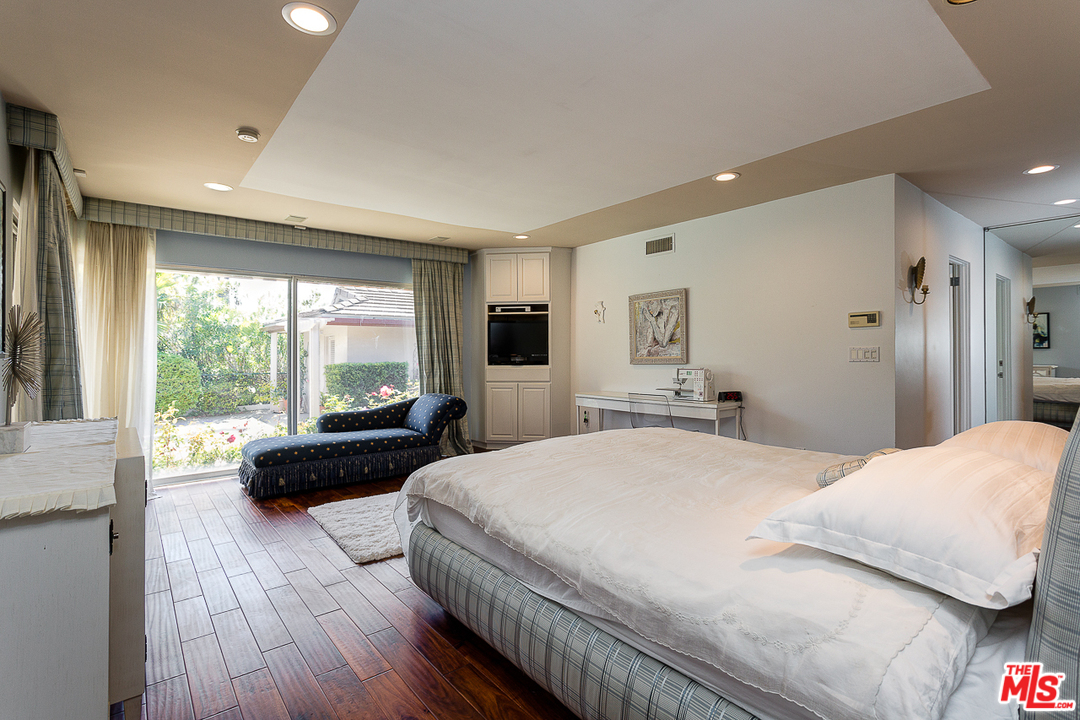 1040 Maybrook Drive Beverly Hills, CA 90210 - Photo 16 of 31 a bedroom with a bed and a large window