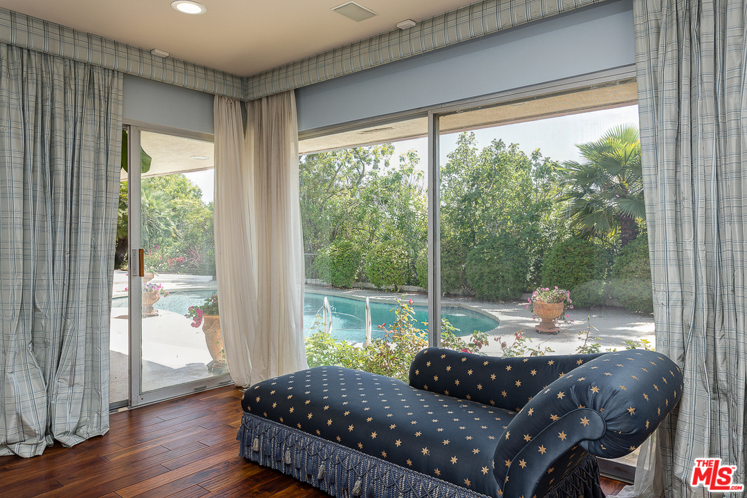 1040 Maybrook Drive Beverly Hills, CA 90210 - Photo 17 of 31 a bedroom with a bed and wooden floor