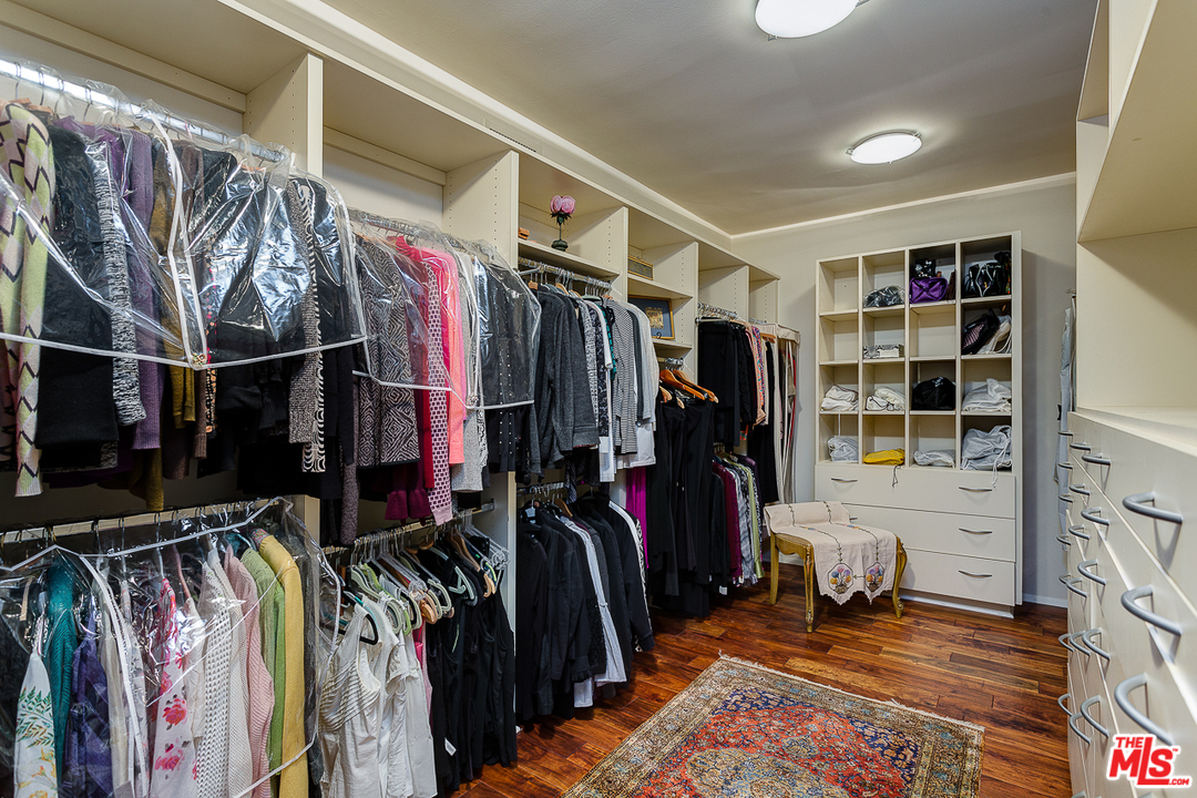 1040 Maybrook Drive Beverly Hills, CA 90210 - Photo 19 of 31 a view of walk in closet with clothes and shoes