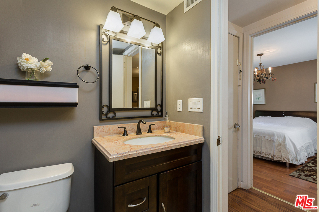 1040 Maybrook Drive Beverly Hills, CA 90210 - Photo 21 of 31 a en suite bathroom with a double vanity sink and a mirror