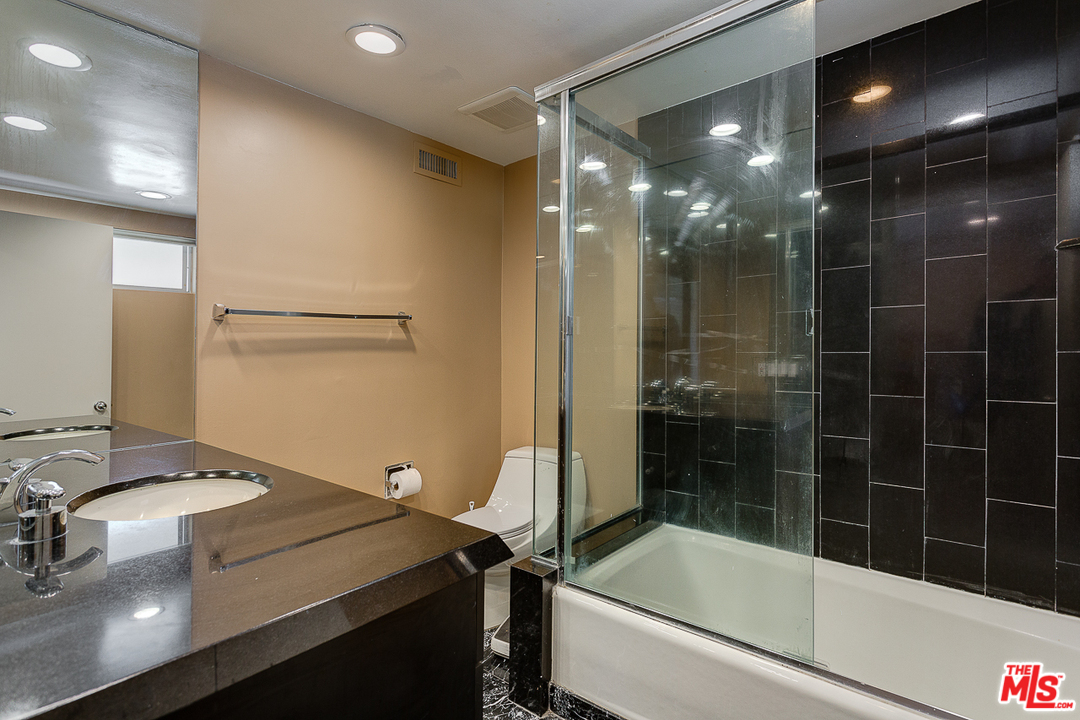 1040 Maybrook Drive Beverly Hills, CA 90210 - Photo 24 of 31 a bathroom with a bathtub and a shower