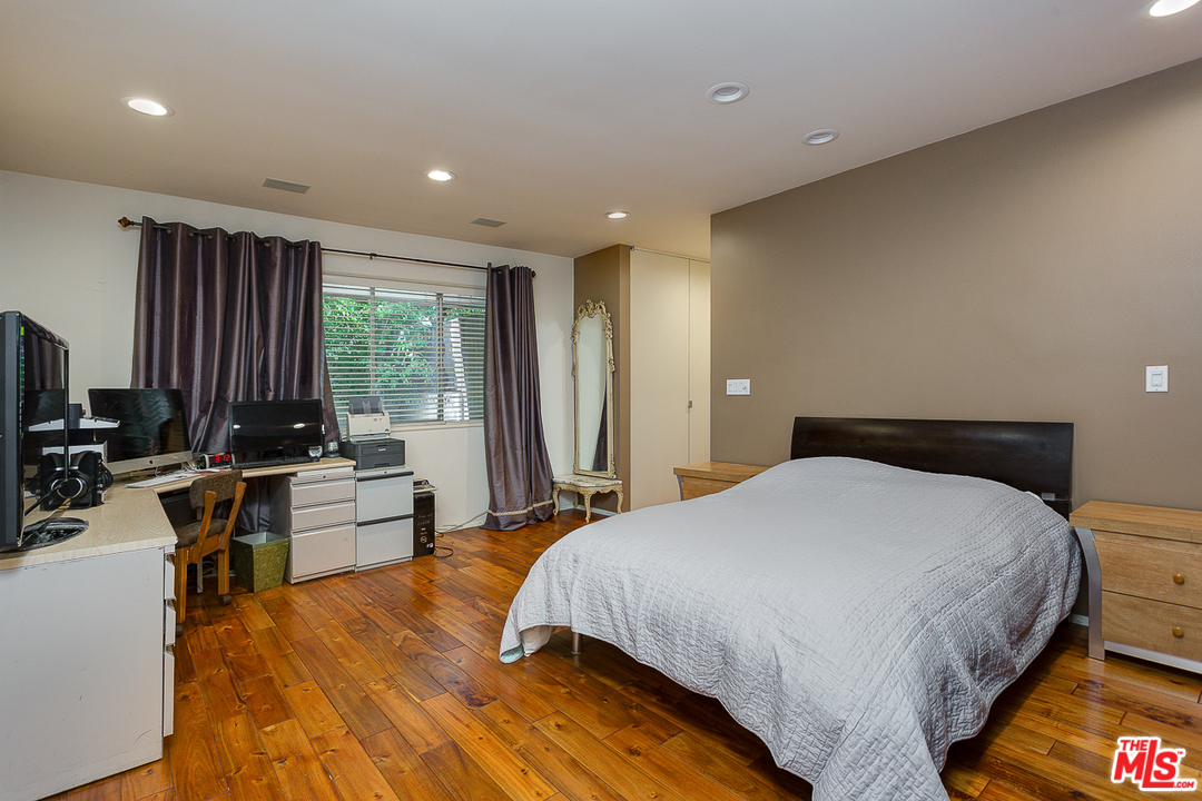 1040 Maybrook Drive Beverly Hills, CA 90210 - Photo 25 of 31 a bedroom with a bed and a large window