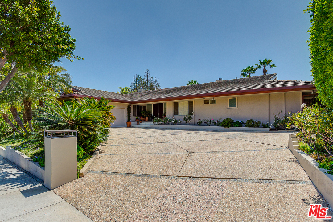 1040 Maybrook Drive Beverly Hills, CA 90210 - Photo 31 of 31 a front view of a house with a yard and a garden