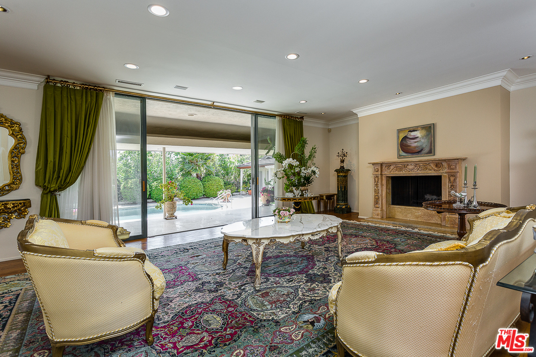 1040 Maybrook Drive Beverly Hills, CA 90210 - Photo 6 of 31 a living room with furniture fireplace and a large window