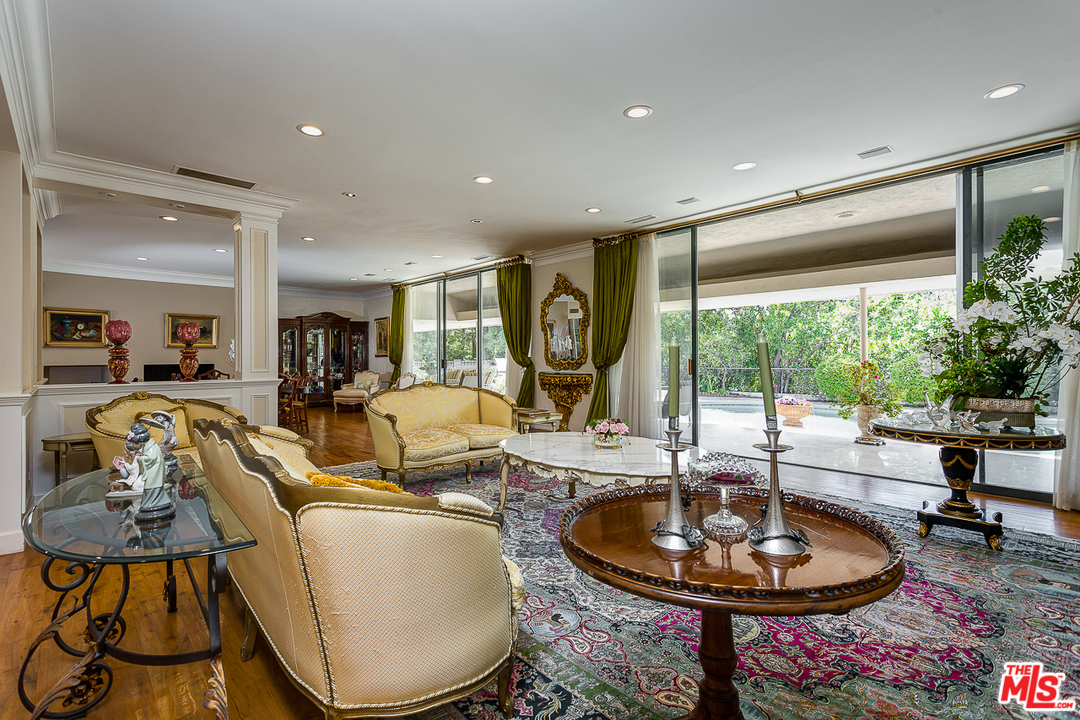 1040 Maybrook Drive Beverly Hills, CA 90210 - Photo 8 of 31 a living room with furniture a large window and a table