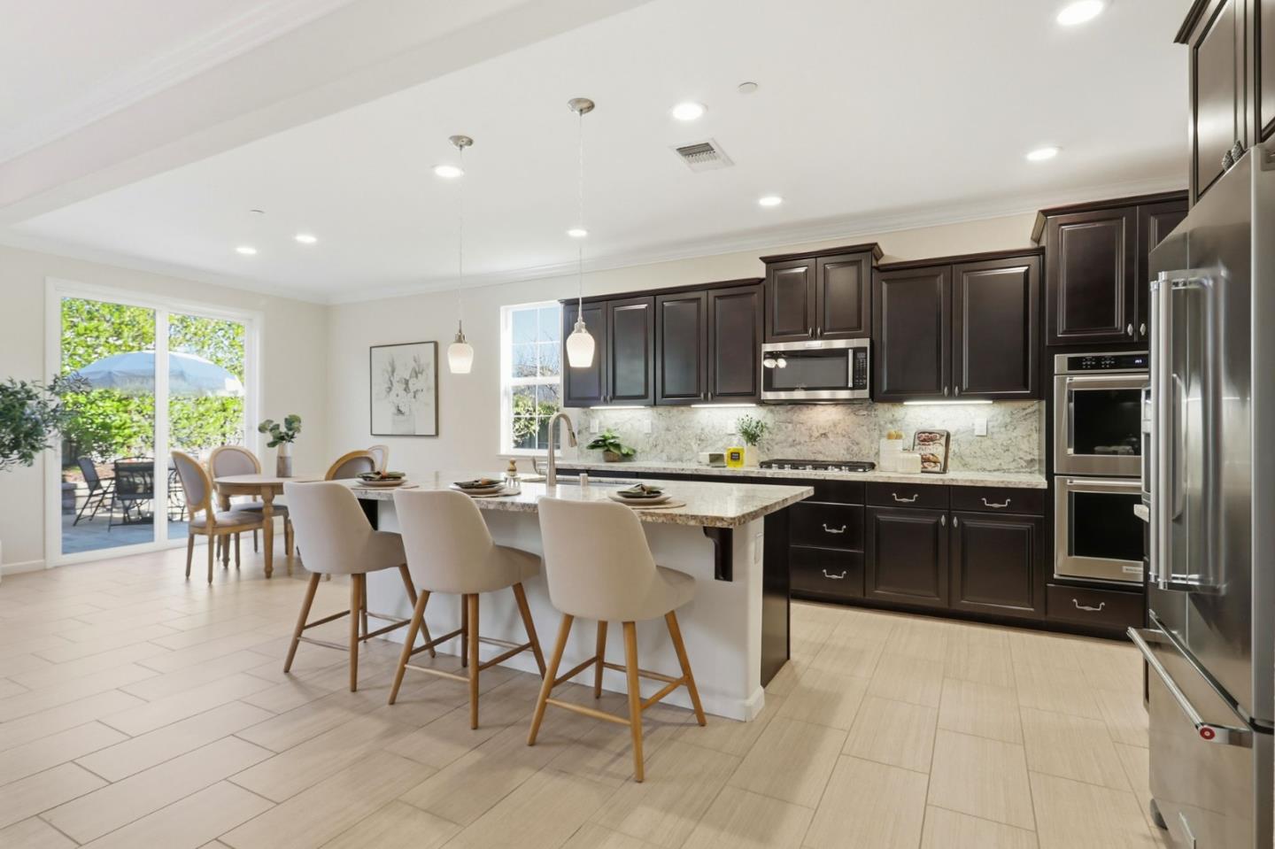 18800 Paprika Drive Morgan Hill, CA 95037 - Photo 17 of 64 a kitchen with stainless steel appliances granite countertop a stove top oven a sink dishwasher a dining table and chairs