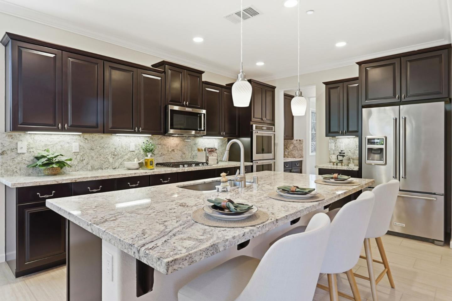 18800 Paprika Drive Morgan Hill, CA 95037 - Photo 19 of 64 a kitchen with granite countertop a table chairs stove and refrigerator with wooden floor