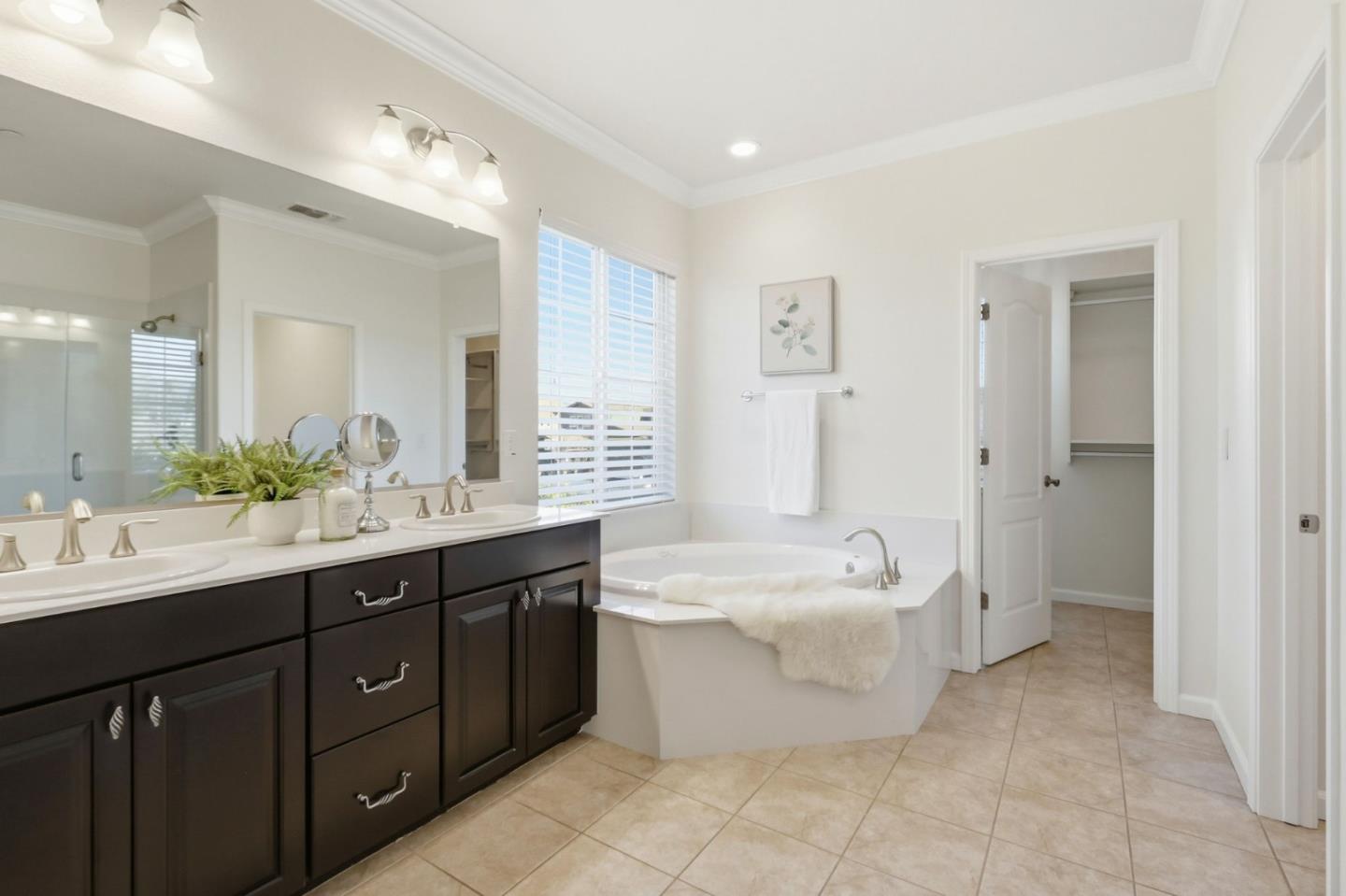 18800 Paprika Drive Morgan Hill, CA 95037 - Photo 50 of 64 a spacious bathroom with a double vanity sink a mirror and a bathtub