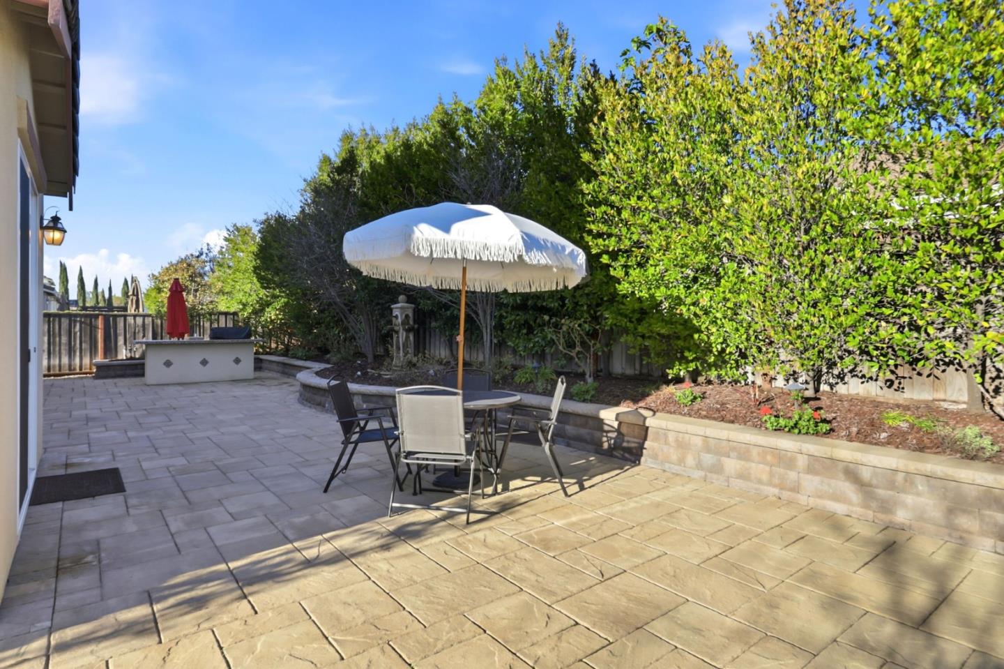 18800 Paprika Drive Morgan Hill, CA 95037 - Photo 55 of 64 a view of a backyard with table and chairs under an umbrella