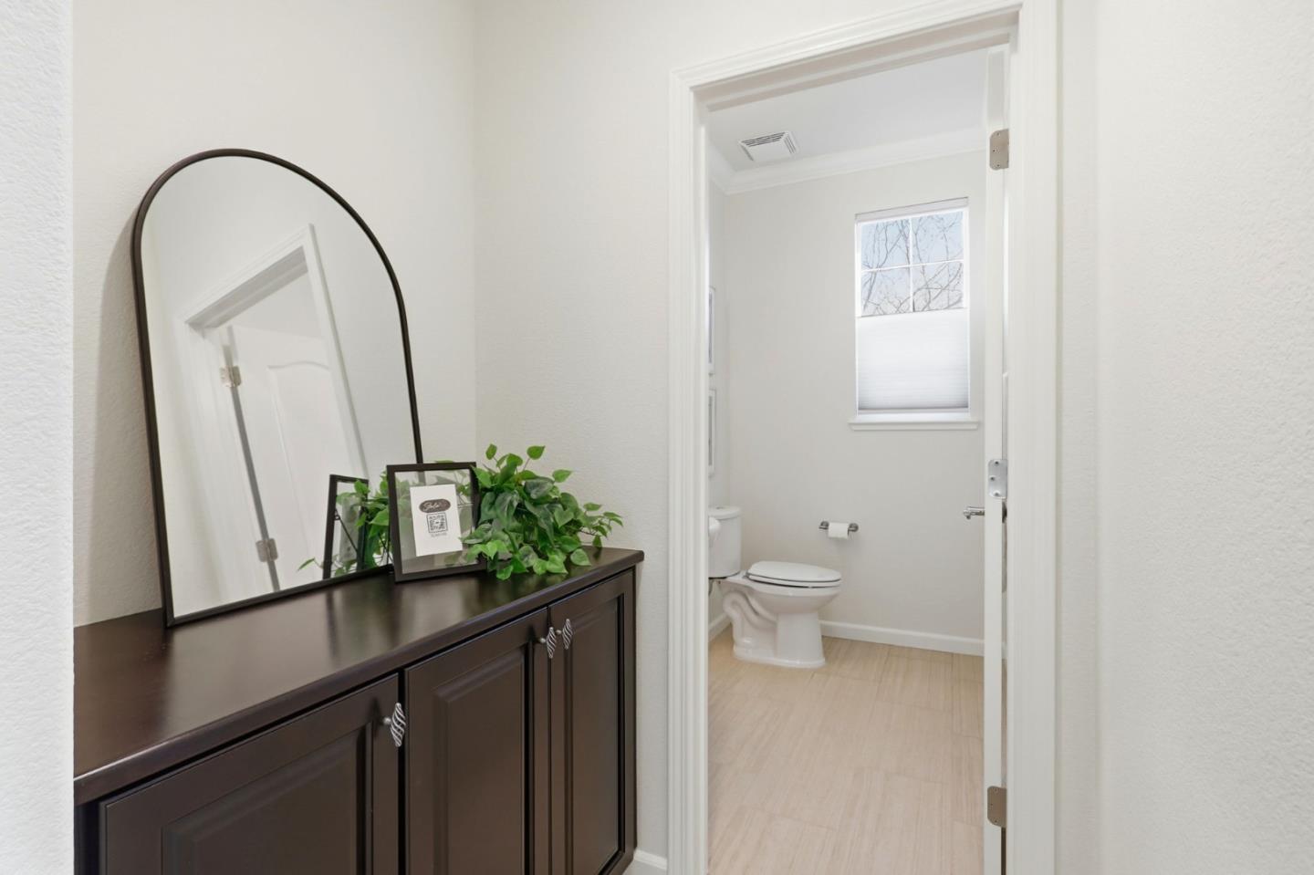 18800 Paprika Drive Morgan Hill, CA 95037 - Photo 8 of 64 a bathroom with a granite countertop sink a toilet and a mirror